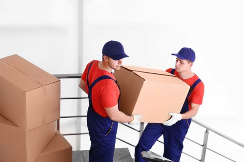 Storage site staff sorting recyclable cardboard and packing materials